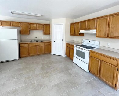 Kitchen with white appliances and sink