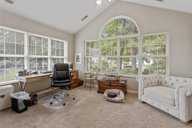 Carpeted office with plenty of natural light and v