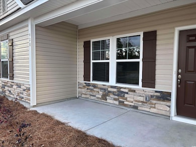 Doorway to property featuring a patio area