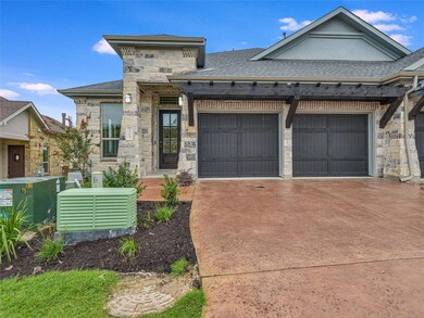 View of front of home featuring driveway, roof wi