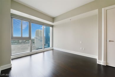 Unfurnished room featuring a view of city, dark wo