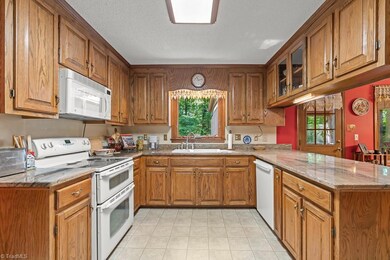 Natural wood cabinetry and beautiful granite blend perfectly with the gorgeous outdoor view.