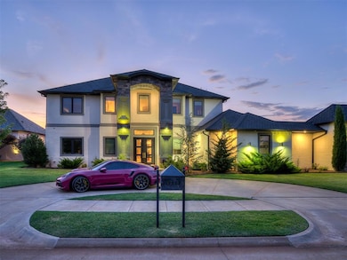 Modern home featuring curved driveway, stucco siding, a lawn, and french doors