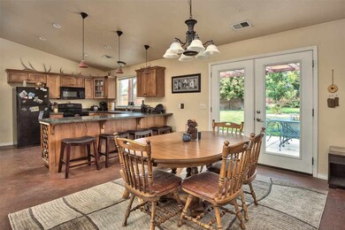 A roomy chandeliered dining area sits between the 