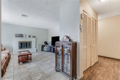Living area featuring a textured ceiling and a bri