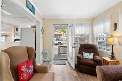 Sitting room with french doors, light hardwood / w