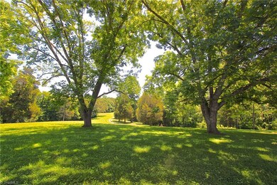 Your view from the front porch framed by very nice mature pecan trees.