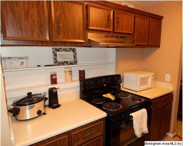 The kitchen has tile floors, plenty of cabinet and