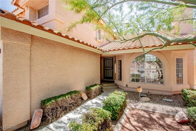 View of exterior entry with stucco siding and a ti