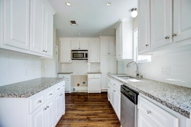 Large kitchen with granite counters and white subw
