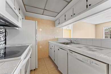 Kitchen featuring white appliances, a sink, light 