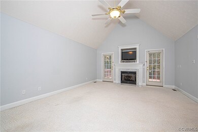 Spacious living room has wall to wall carpet, cath