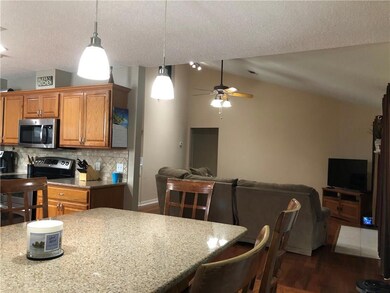 Granite breakfast bar is welcoming to the kitchen