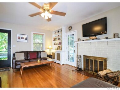 The living room has hardwood floors, built-in book