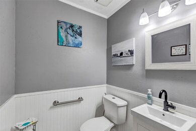 This is a modern, well-lit half-bath featuring neu