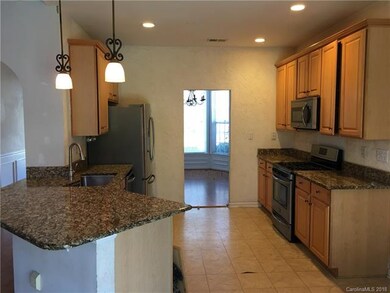 Open kitchen with stainless steel appliances, and 
