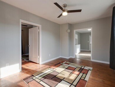 The living room of this home contains hardwood flo