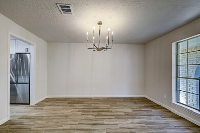 This dining space is brightened by an oversized wi