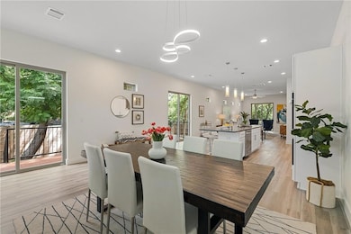Dining space with plenty of natural light, visible vents, recessed lighting, and light wood-style floors