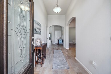The photo showcases a welcoming entryway with a de