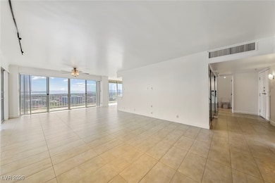 Unfurnished living room with a ceiling fan and lig