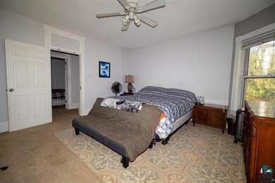Bedroom with carpet flooring and ceiling fan