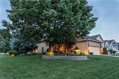 The large grassy front yard is impeccably landscap