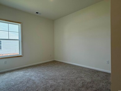 Carpeted empty room with baseboards