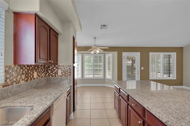 Kitchen with light tile patterned floors, baseboar