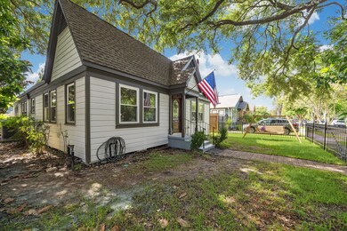 Yard wrapping around the house with mature trees p