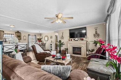 Living room with ornamental molding, ceiling fan w