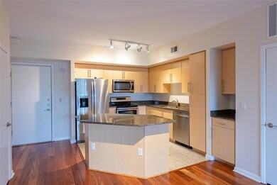 Kitchen featuring dark stone countertops, a cente