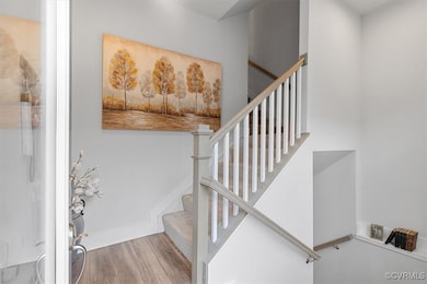 Stairs with baseboards and wood finished floors