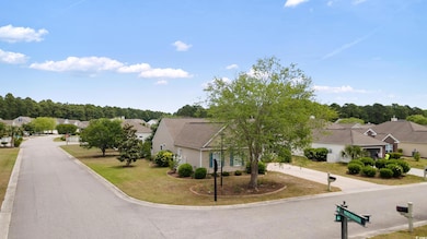 View of asphalt street featuring a residential vie