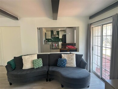 Living area with beamed ceiling and wood finished 