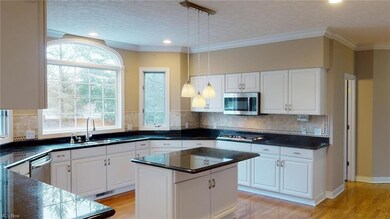 Extra large gourmet kitchen boasts white cabinets 