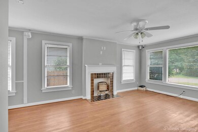 Unfurnished living room featuring crown molding, a