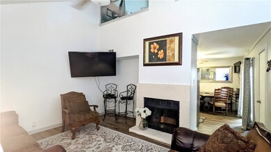 Living room with tons of light, vaulted ceiling, wood burning fireplace, new flooring.