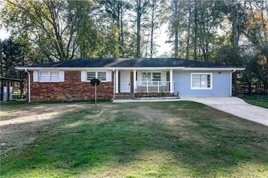 Ranch-style house with a front yard and a porch