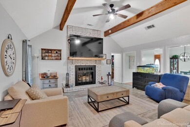 Living area featuring a fireplace, vaulted ceiling