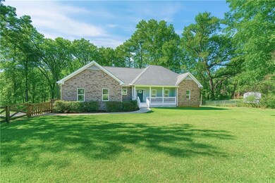Ranch-style home with a porch and brick siding