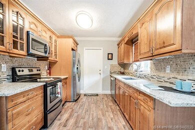 New Kitchen with Wood cabinetry, Granite Counter Top and SS Appliances. Exterior door with access to side of the house