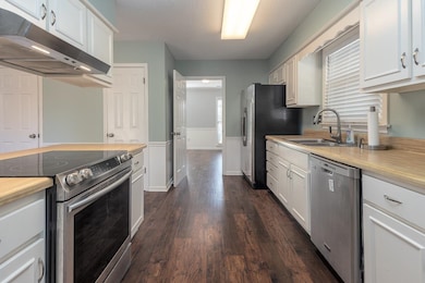 Kitchen with dark hardwood / wood-style flooring, 