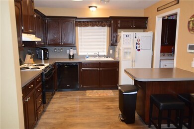 Large kitchen with eating bar, refinished wood cab