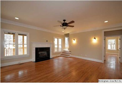 Large living room with hardwood floors and gas log