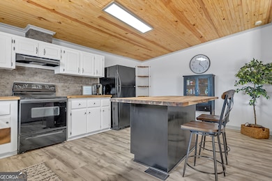 Crisp white cabinets complement the warm tones.