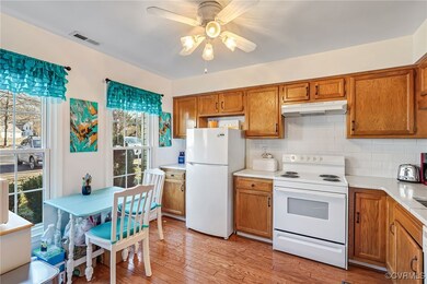 Kitchen featuring ceiling fan, white appliances, d