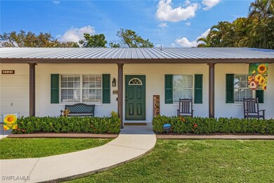View of front of house with metal roof, a porch, a