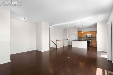 Unfurnished living room with dark wood finished floors