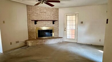 Unfurnished living room featuring ceiling fan, bri
